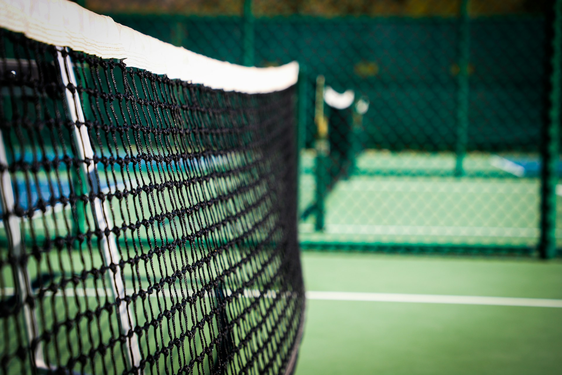 Pickleball players competing on an indoor court